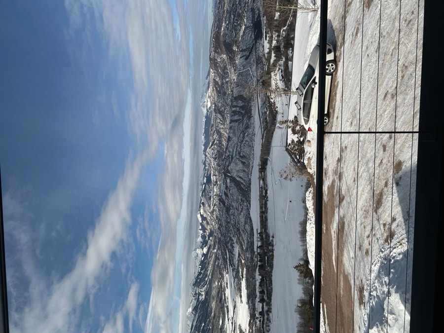 Aerial or elevated view of snow-covered Aspen valley with mountain range