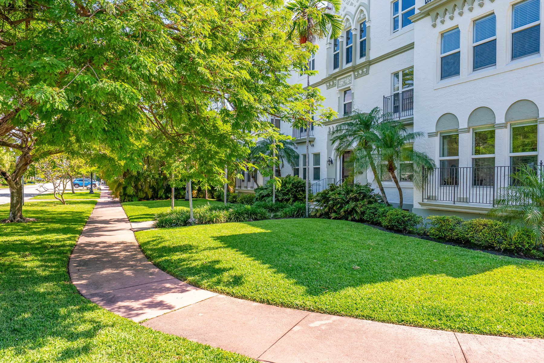 The walk to the entry. A 1925 Mediterranean revival building on a Mid Beach residential street — the kind of facade you cannot recreate at any price point in new construction.