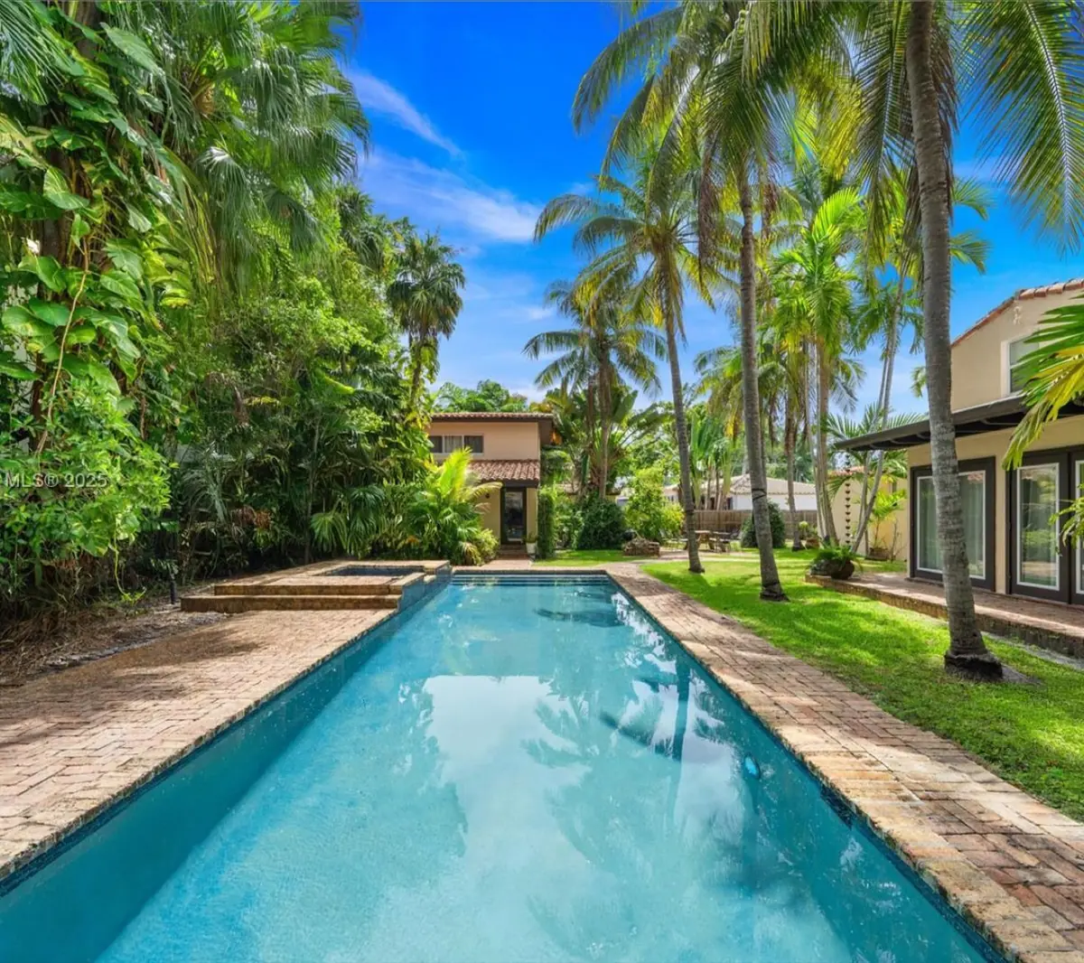 The backyard and pool — charming, but a house built below base flood elevation with no path forward.