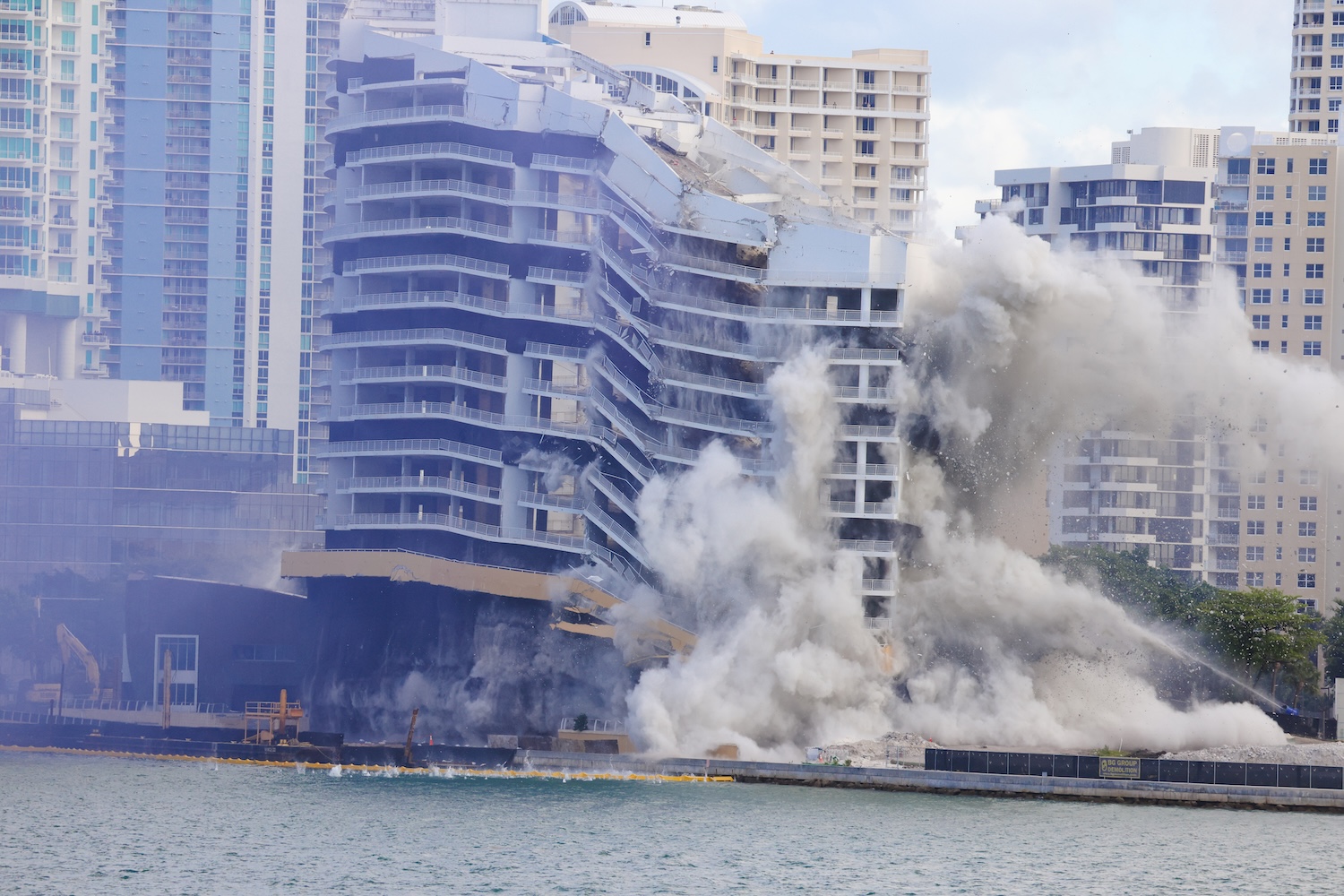 The original 23-story Mandarin Oriental tower and the adjacent garage coming down at 8:30 AM on Sunday, April 12, 2026. The largest controlled implosion in Miami in over a decade.